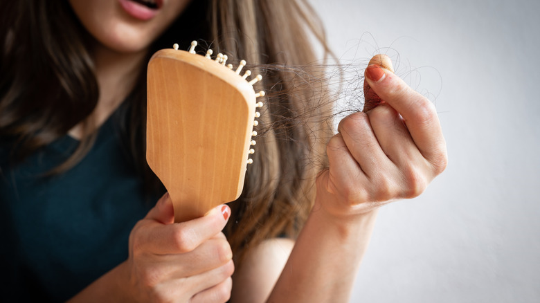 Woman finding hair in her brush