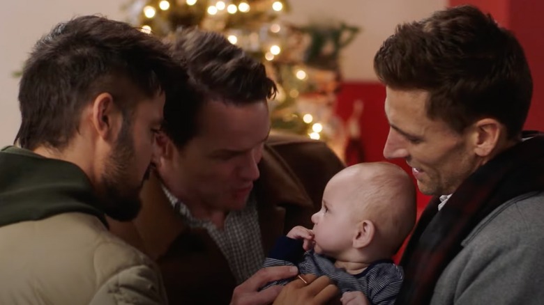 Paul Campbell, Andrew Walker, and Tyler Hynes with a baby