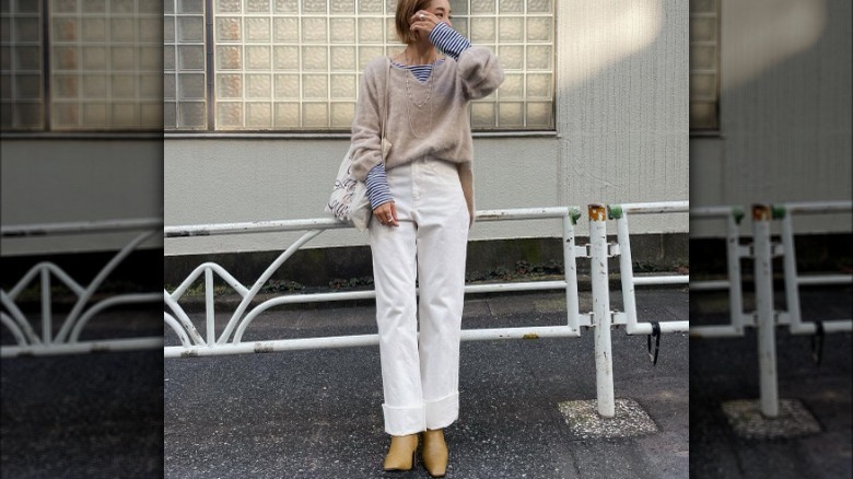 Woman in cuffed white denim