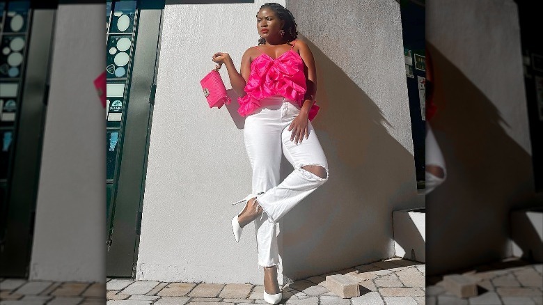 Woman in pink top and white denim