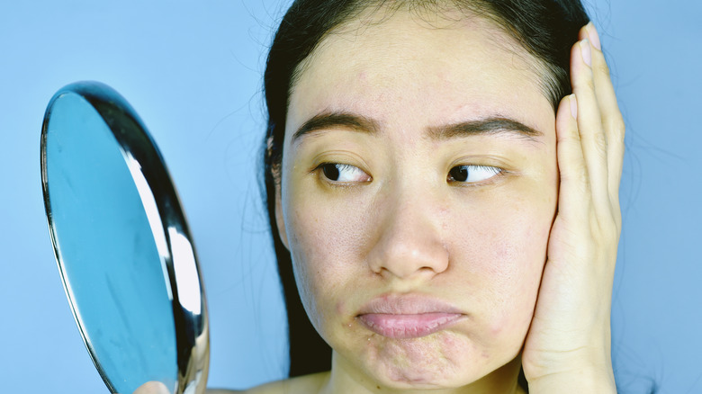 Woman looking at skin