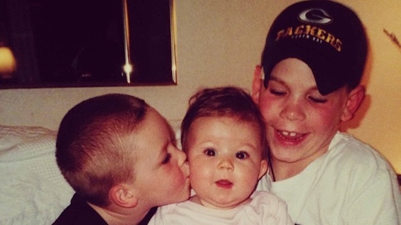 Karoline Leavitt as a baby with her two older brothers