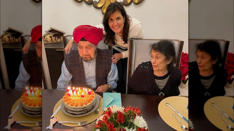 Nikki Haley smiling while her dad and mom look it his birthday cake