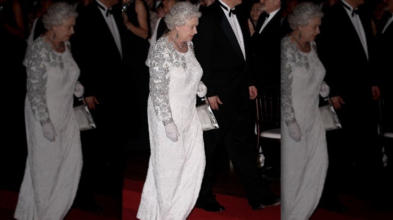 Queen Elizabeth II wearing long white dress and tiara