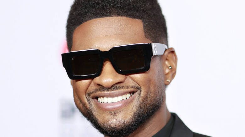 Usher grinning in sunglasses