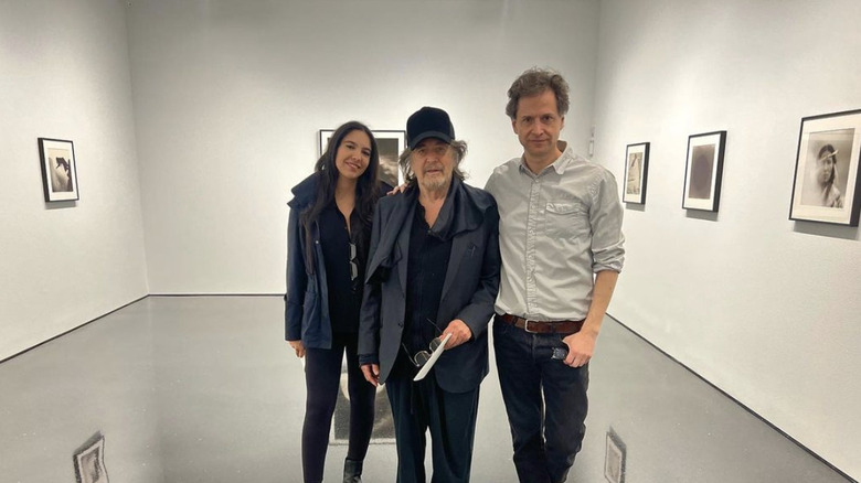 Noor Alfallah and Al Pacino posing at an art gallery