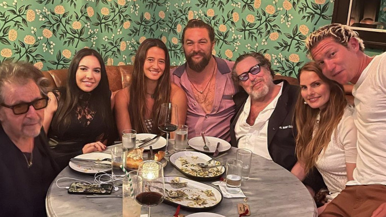 Al Pacino, Noor Alfallah, Jason Momoa, and friends at a restaurant