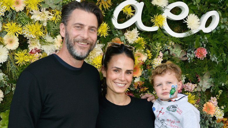 Andrew Form and Jordana Brewster posing with their son