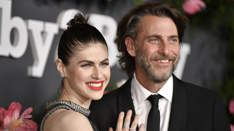 Alexandra Daddario and Andrew Form posing on step-and-repeat