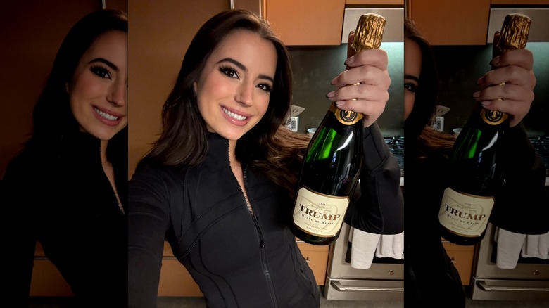 Ashley St. Clair holding Trump brand champagne