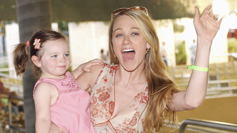 Christine Taylor carrying young Ella in 2004