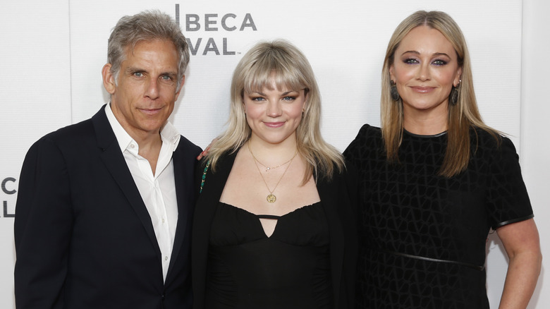 Ben Stiller, Ella Stiller and Christine Taylor smiling on a red carpet