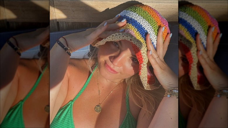 Ella Stiller takes a selfie in a colorful hat