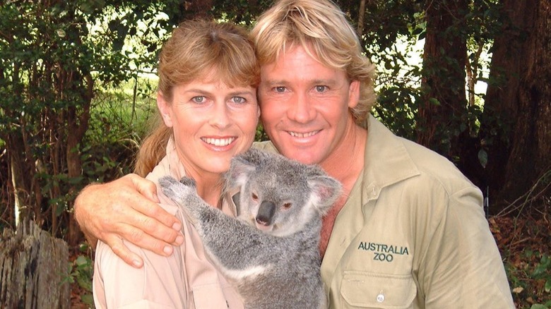 Steve and Terri holding a koala and smiling