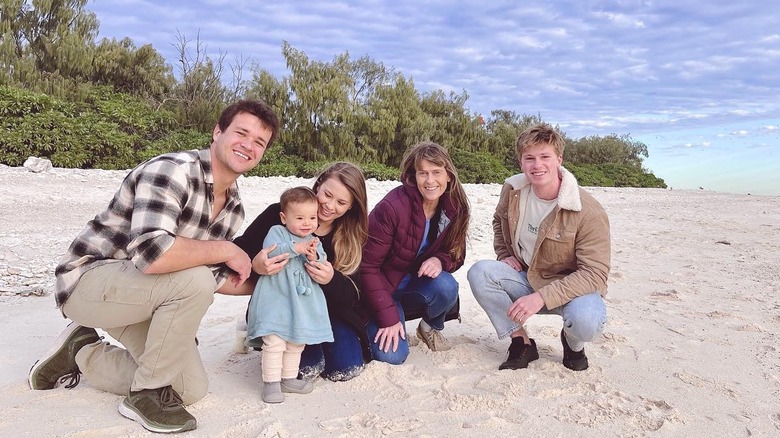 Terri and her family sitting on the beach