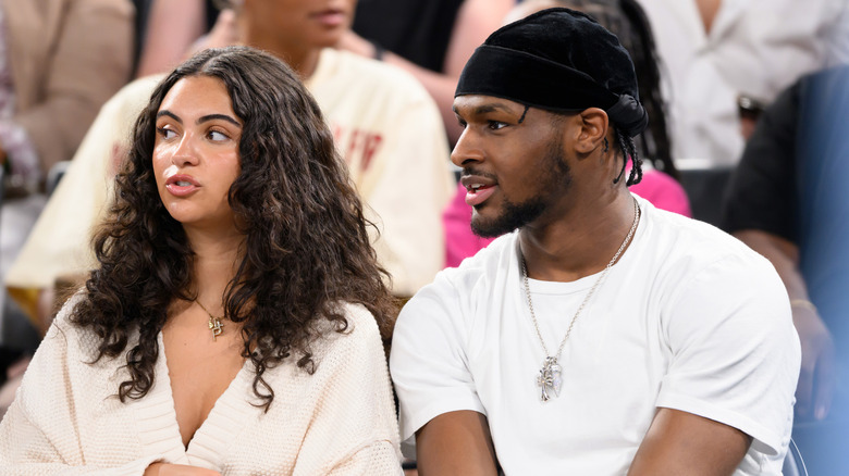 Bronny James and Parker Whitfield sitting courtside