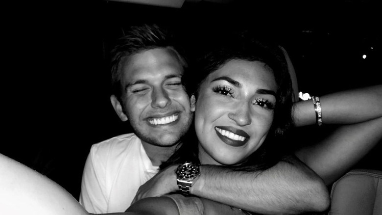 Kayla and Chase smiling at the camera in a black and white photo