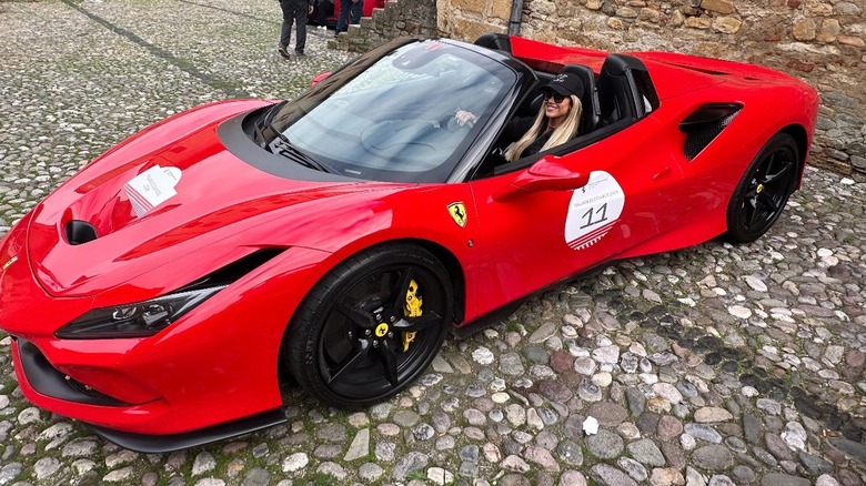 Christina Hall, also known as Christina Haack, sitting in the front seat of a Ferrari