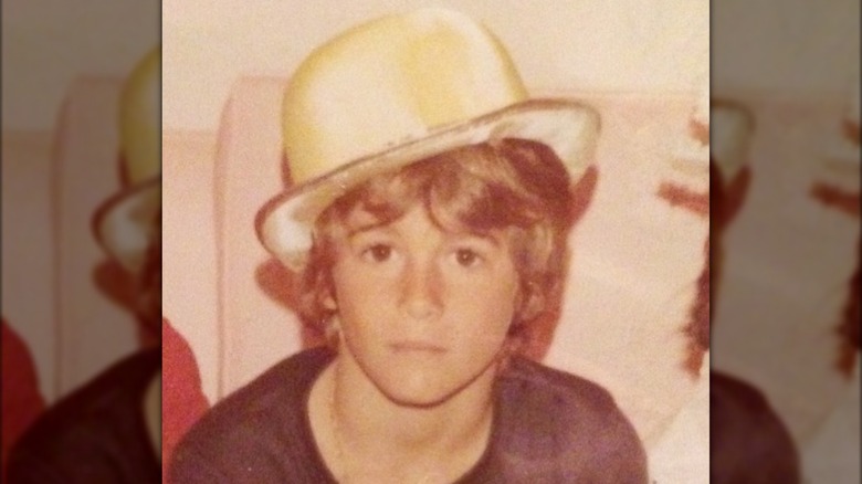 Young Rande Gerber wearing a hat