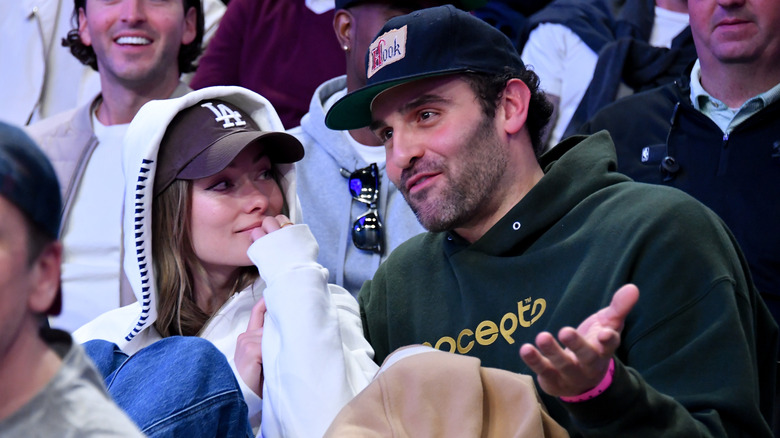 Olivia Wilde and Dane DiLiegro sitting in crowd