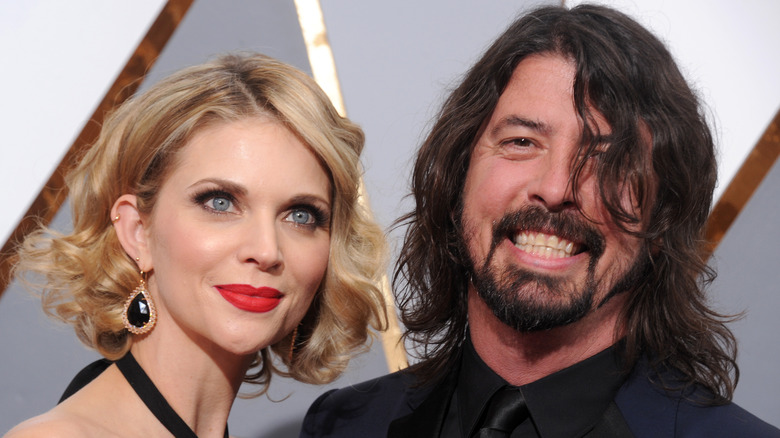 Close up of Jordyn Blum with short blonde hair and red lips and Dave Grohl with beard and black shirt