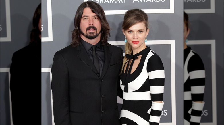 Jordyn Blum with dark hair and black and white dress with Dave Grohl in black suit and tie