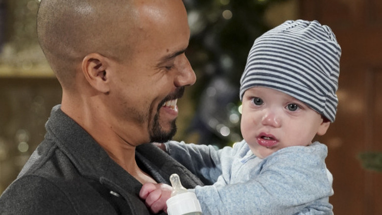 Bryton James as Devon with Baby Dominic