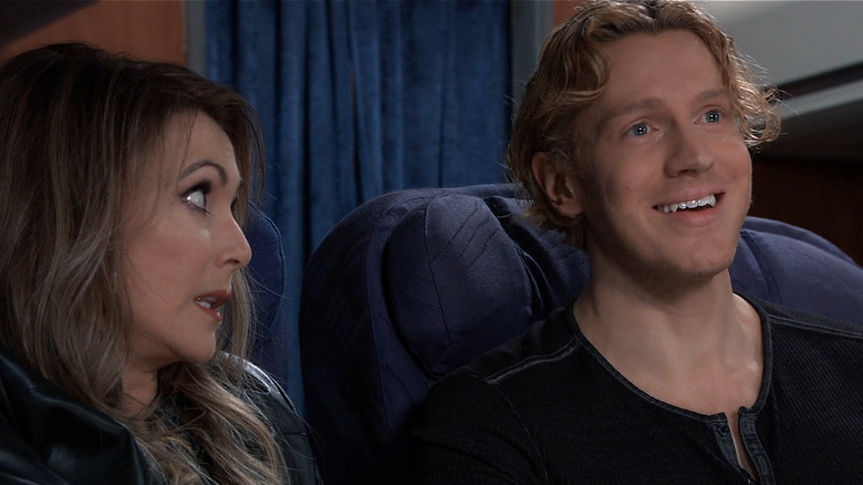 Holly and Ethan talking on a plane