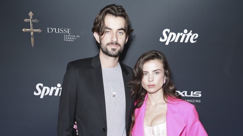 Conor Kennedy and Giulia Be posing at an event