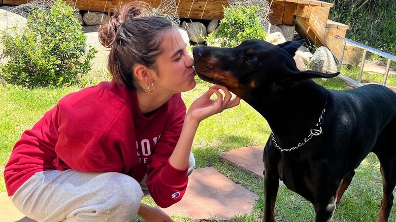 Leila Mathison kissing a dog