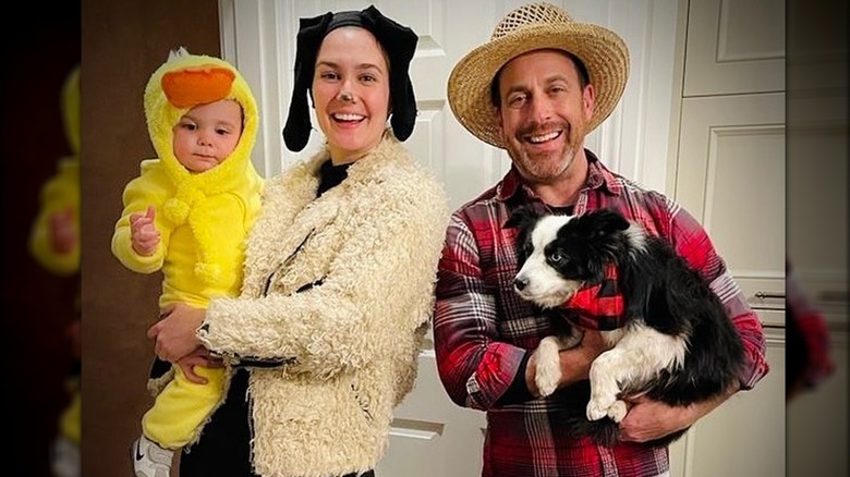 Katherine Barrell and Ray Galletti posing with their son