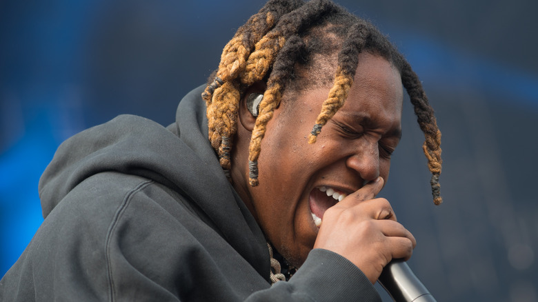 Don Toliver singing into microphone