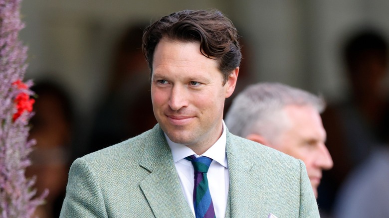 Lt. Col. Jonny Thompson smiling in a green suit