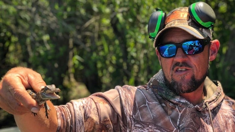 Jeremy Dufrene holds a baby gator