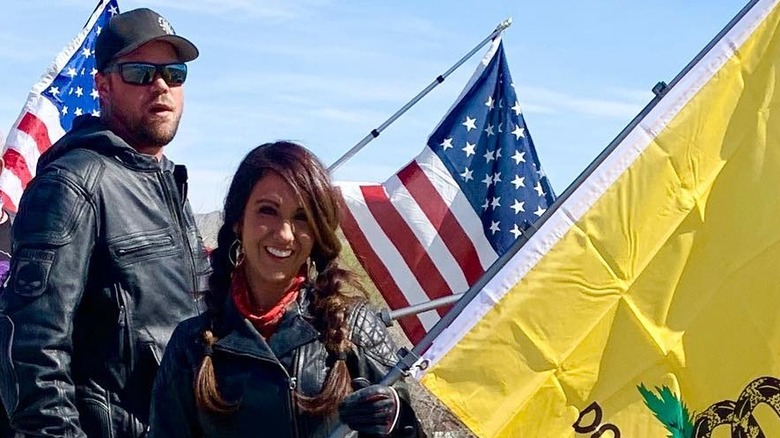 Lauren Boebert and Jayson Boebert holding flags