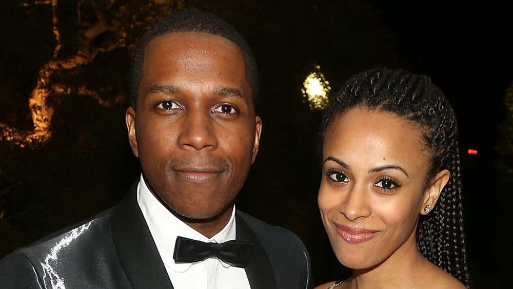 Nicolette Robinson and Leslie Odom Jr.grinning on the red carpet