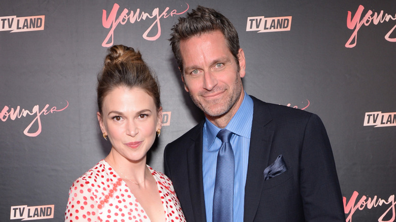 Peter Hermann and Sutton Foster posing for photos