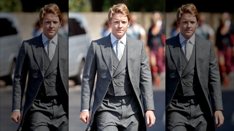 Hugh Grosvenor walking in gray suit