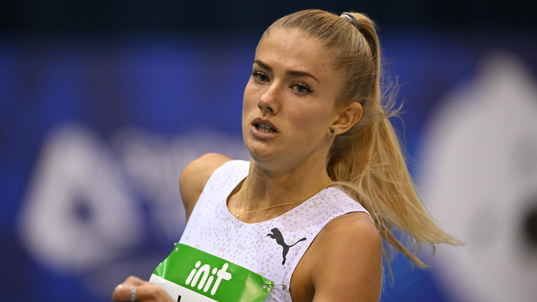 Alica Schmidt running in a white outfit