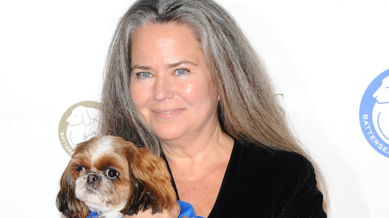 Koo Stark holding a dog