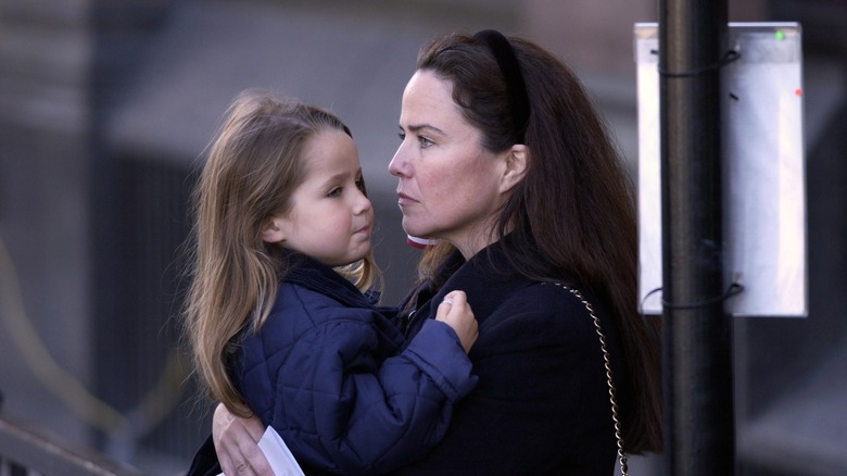 Koo Stark holding her daughter