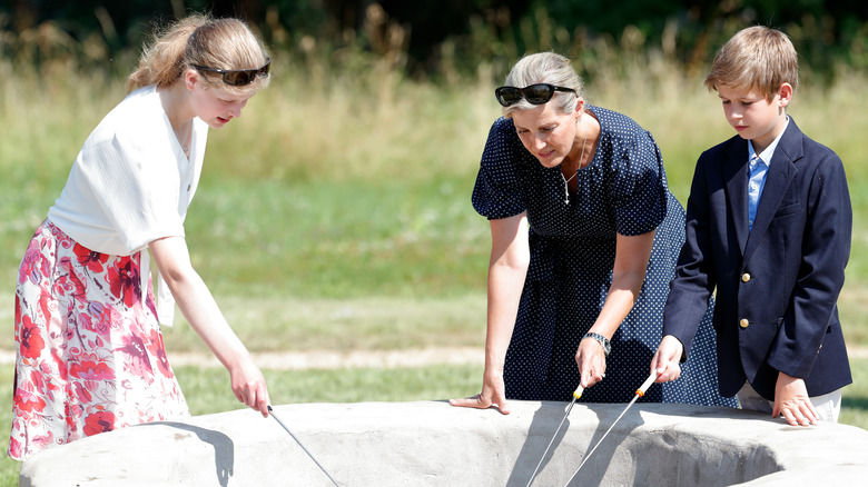 Viscount Severn participating in an activity with his sister and mother