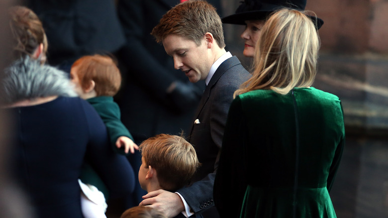 Hugh Grosvenor with arm around boy in crowd