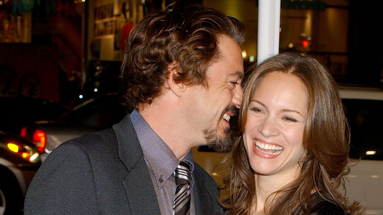 Robert Downey Jr. whispering in Susan's ear laughing