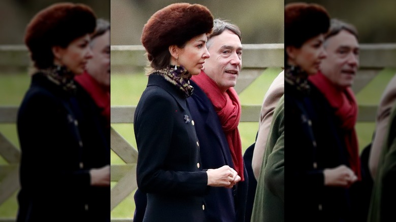 Rose Hanbury in fur hat walking with David Cholmondeley in red scarf