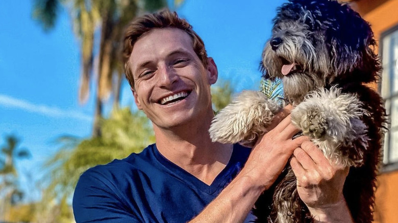 Garrett Schwartz holding a dog