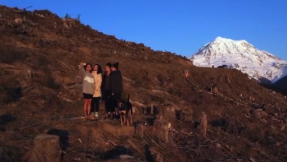 Kimberly Courneya and her siblings taking a selfie on the mountainside