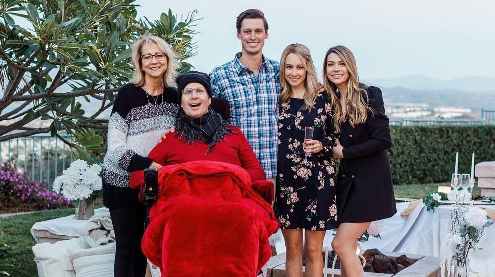 Sarah trott posing with her family and father with ALS