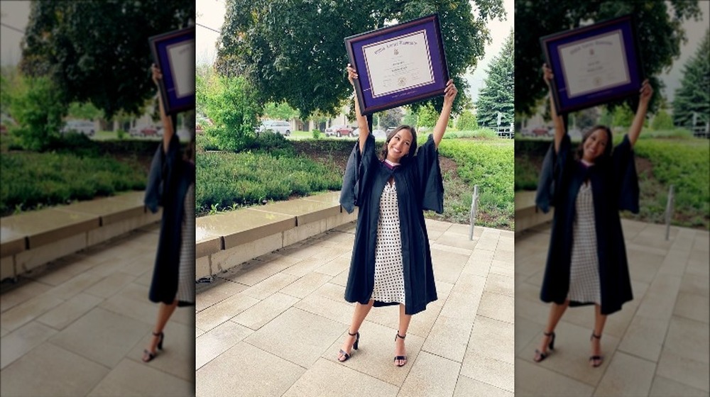Serena Pitt holding her diploma