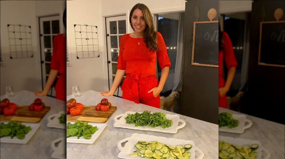 Victoria Larson  standing behind plates of veggies